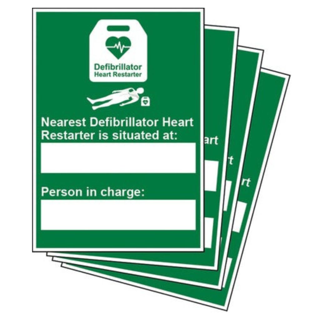 Stack of green signs with text about defibrillator location on a white background