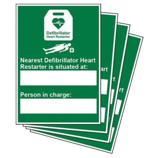 Stack of green signs with text about defibrillator location on a white background
